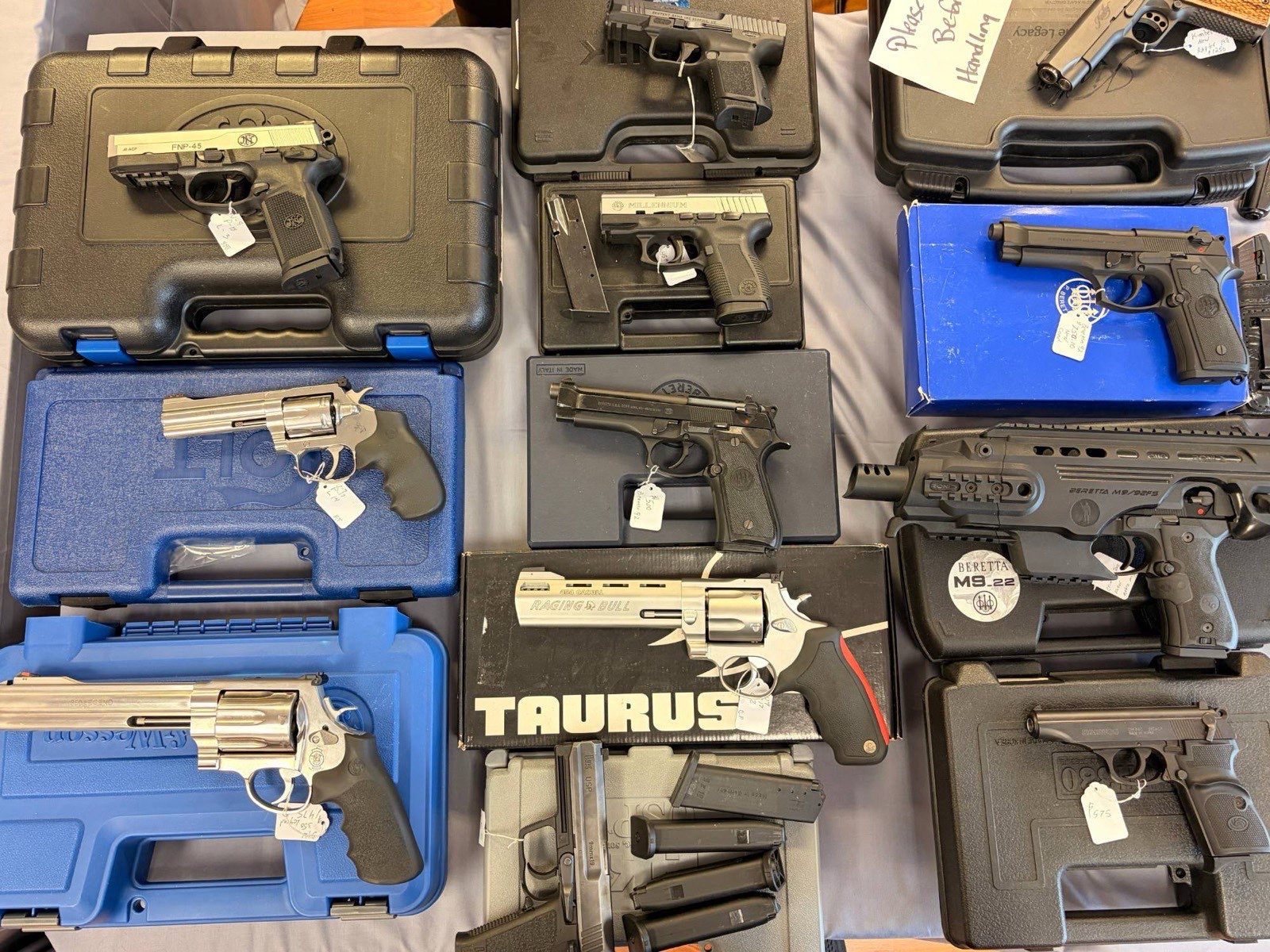 A wall of pre-owned firearms in the display case